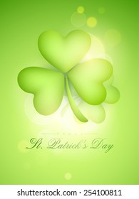 Creative glossy shamrock leaf on shiny green background for Happy St. Patrick's Day celebration.
