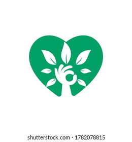 Creative green hand tree and heart logo design. Natural products logo. Cosmetics icon. Spa logo. Beauty salon or yoga logo.	