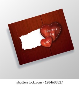 Creative greeting card design with stitched heart shape on wooden texture background for Valentine's Day celebration.