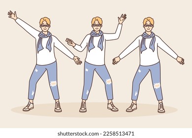 Creative guy in youth fashion clothes posing taking different poses and spreading arms to sides. Young man in short pants with patches and scarf around neck demonstrates clothes during fashion show 