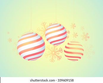 Creative hanging Xmas Balls on snowflakes decorated glossy background for Merry Christmas celebration.