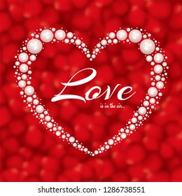 Creative heart shape made by pearls with stylish lettering of love on red blurred background for Valentine's Day.