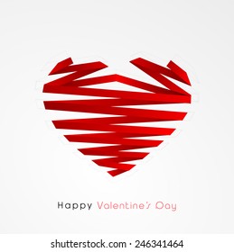Creative heart shape made by red paper stripe on grey background for Happy Valentines Day celebration.
