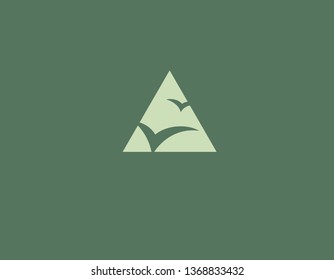 Creative logo triangle and silhouette of birds in flight for company