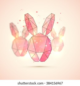 Creative Origami Bunny Face made by glitter on shiny background for Happy Easter celebration.