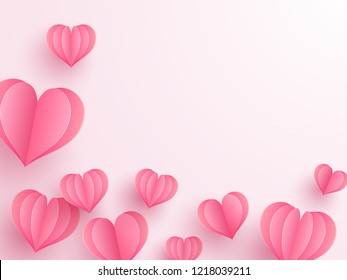 Creative paper cut heart decorated glossy pink background with space for your text.