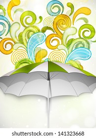 Kreativer Hintergrund der Regenzeit mit offenem Regenschirm.