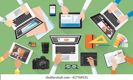 Creative team working together at office desk, teamwork and advertising concept