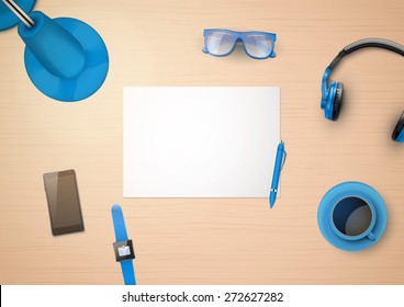 Creative workplace with white paper and stylized in blue color household items and gadgets. Top view.