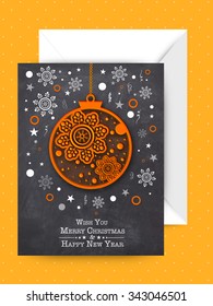Creative Xmas Balls and snowflakes decorated greeting card with envelope for Merry Christmas and Happy New Year celebration.