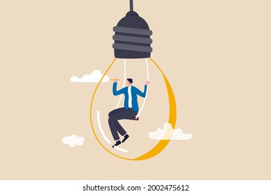 Creativity and imagination to create content, writer or creator inspiration for new idea, think and brainstorm concept, motivated man sitting on swing inside lightbulb idea using pencil drawing cloud.