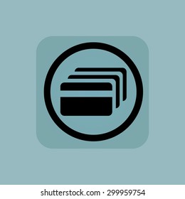 Credit card in circle, in square, on pale blue background