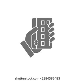 Credit card with hand, credit card payment grey fill icon. Shopping, online banking, finance symbol design.