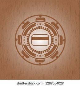 credit card icon inside wooden emblem