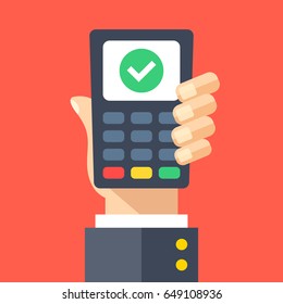 Credit card machine with check mark. Hand holding point of sale, pos, payment terminal with tick checkmark on screen. Transaction approved, successful purchase. Modern flat design vector illustration