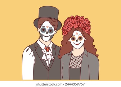 Creepy couple dressed up to celebrate halloween and create scary atmosphere at night party. Young man and woman with painted faces to participate in masquerade on eve of halloween