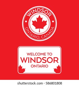 A crest and a welcome sign for Windsor, Ontario, Canada that features maple leaves.