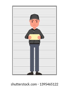 A criminal with a tablet in his hands is standing at the stand for measuring growth and photographing. Isolated on a white background.