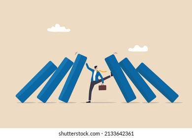 Crisis management, leadership to manage disaster situation, challenge to overcome difficulty in economic crisis concept, confident businessman use his hand to stop domino fall and foot to stop others. - Shutterstock ID 2133642361