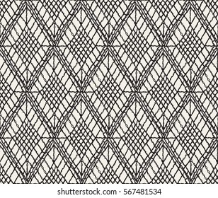 Crochet seamless pattern. Knitted or woven macrame in the bohemian style. Oriental motifs. Knitting mesh