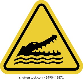 Crocodile sign. Aligator sign. Sign is located near ponds, parks and other natural areas where crocodiles may be found. Warning yellow triangular sign.