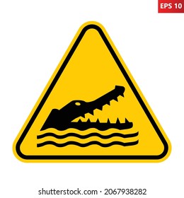 Crocodiles, alligators, caimans warning sign. Vector illustration of yellow triangle sign with reptile head with open jaws. Caution wild dangerous animals. Danger zone. Risk of attack.