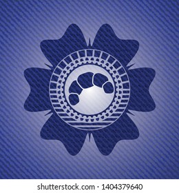 croissant icon inside badge with denim texture