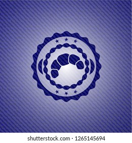 croissant icon inside denim background