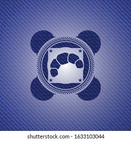 croissant icon inside denim background