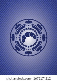 croissant icon inside denim background