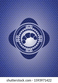croissant icon inside emblem with jean background