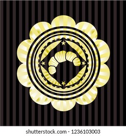 croissant icon inside gold emblem