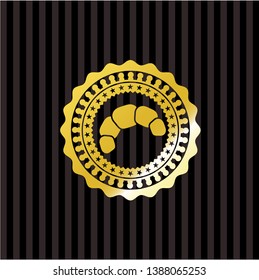 croissant icon inside golden emblem