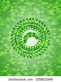 croissant icon inside green emblem with triangle mosaic background