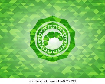 croissant icon inside green emblem with triangle mosaic background