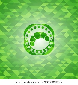 icono croissant dentro del emblema verde con fondo de mosaico. 