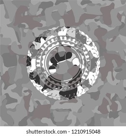 croissant icon inside grey camo emblem