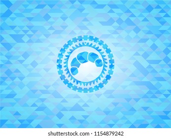 croissant icon inside light blue emblem with triangle mosaic background