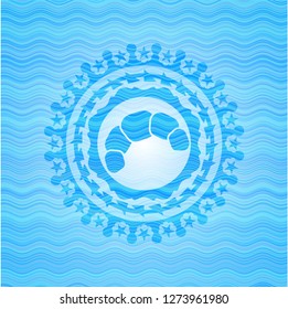 croissant icon inside light blue water wave emblem.