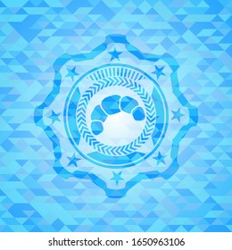 croissant icon inside realistic light blue mosaic emblem