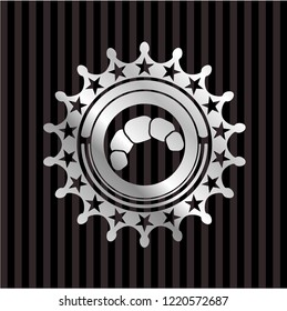 croissant icon inside silver emblem