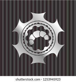 croissant icon inside silver emblem