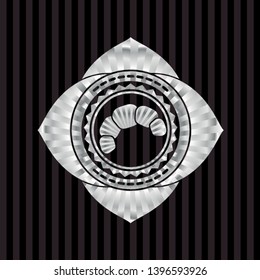 croissant icon inside silver emblem or badge