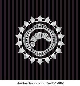 croissant icon inside silvery badge