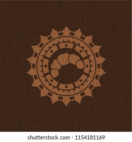 croissant icon inside vintage wooden emblem