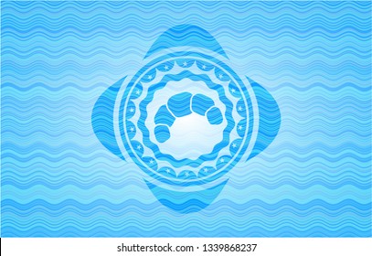 croissant icon inside water representation badge background.