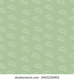 Croissant seamless pattern on a green background