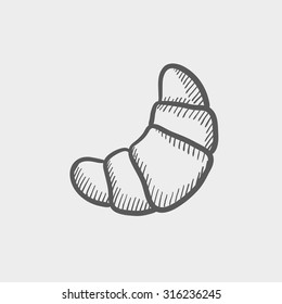 Croissant sketch icon for web, mobile and infographics. Hand drawn vector dark grey icon isolated on light grey background.