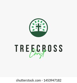 a cross with leaves around it logo design