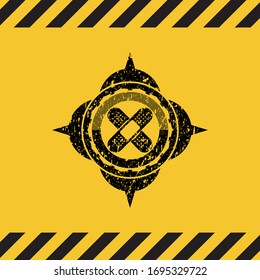 crossed bandage plaster icon black grunge emblem inside yellow warning sign. Vector Illustration. Detailed.